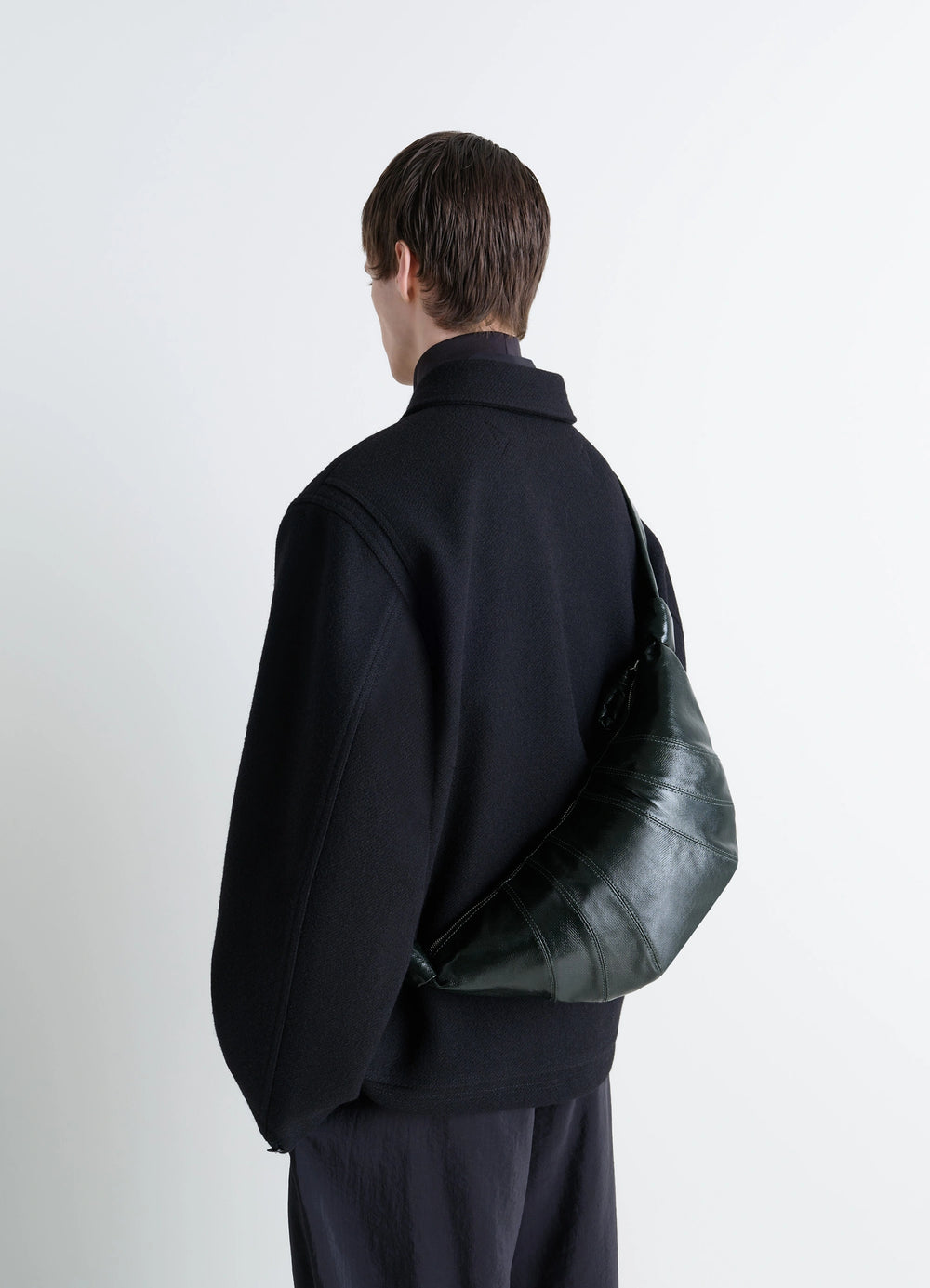 Lemaire Medium Croissant Bag in Shiny Coated Cotton Canvas, model shot, back view slouch style on shoulder