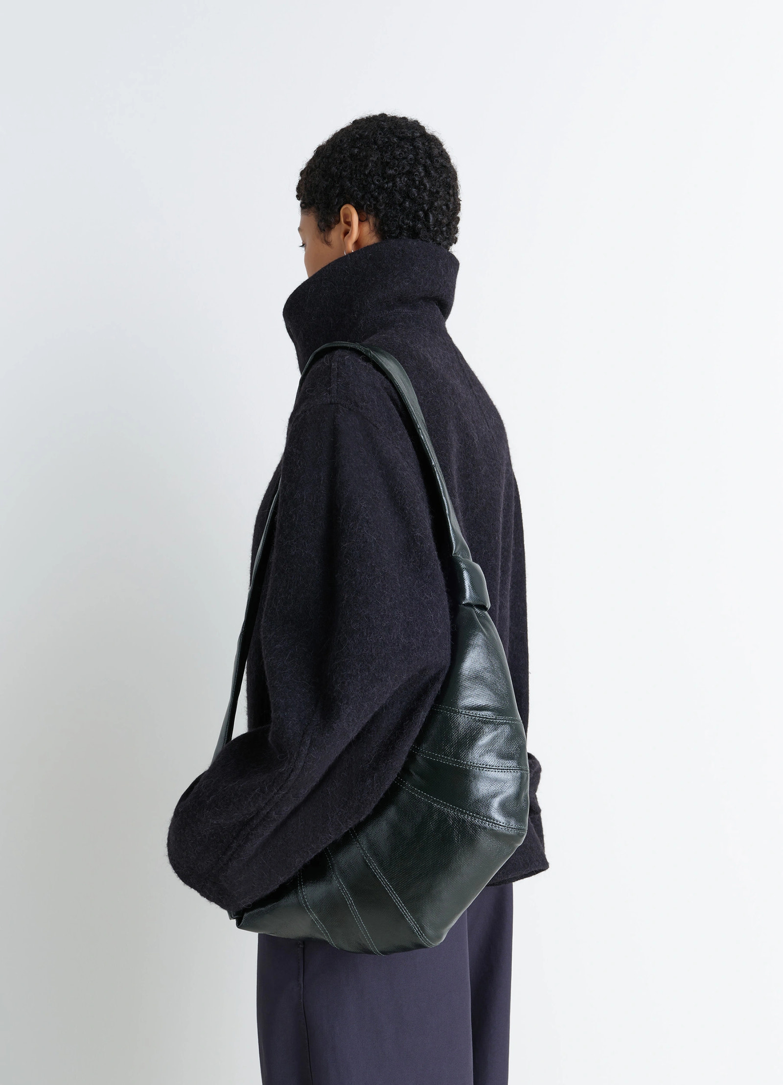 Lemaire medium croissant bag in shiny coated cotton canvas, model shot, side view curved, topstitched panels