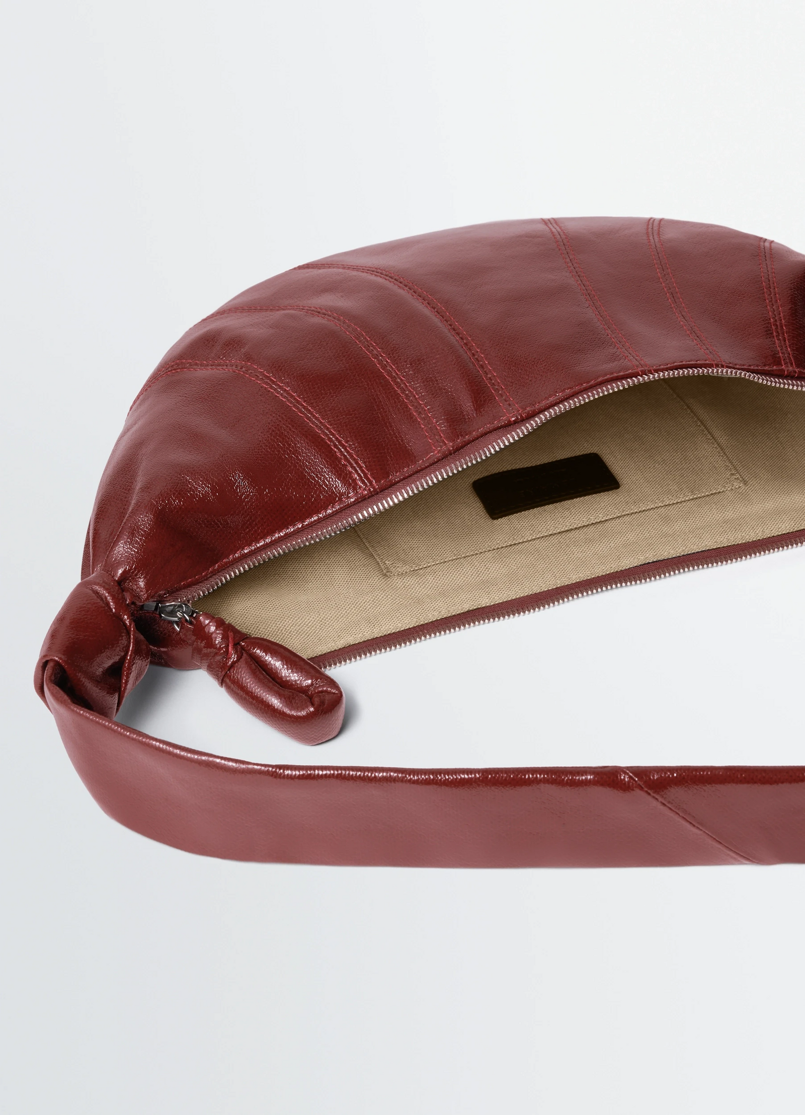 Medium croissant bag in coated cotton, product shot, detail shot zipper closure detail