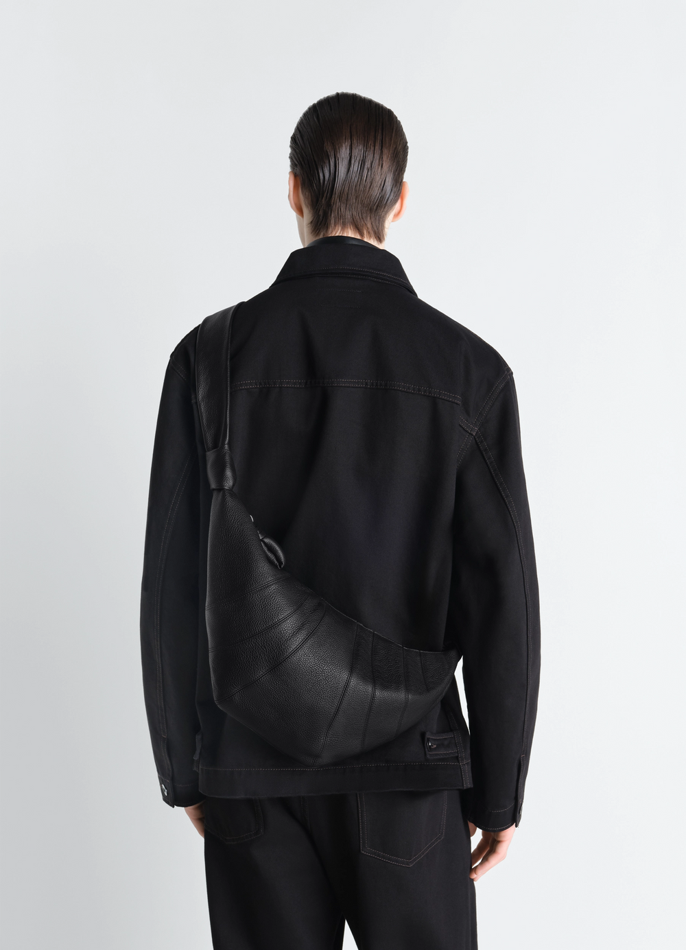 Medium Croissant Bag in Grained Leather, model shot, back view curved shoulder strap