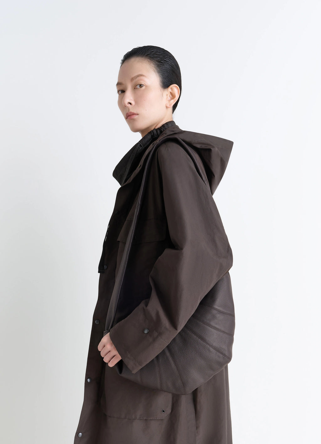 Lemaire Medium Croissant Bag in Grained Leather, model shot, three-quarter view textured surface detail