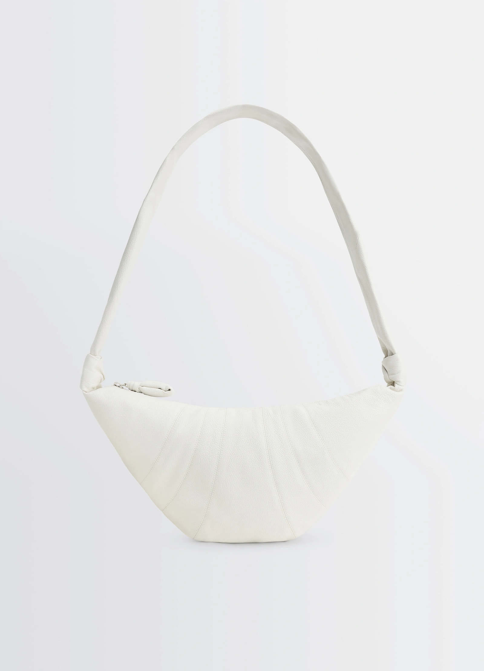 Lemaire medium croissant bag in soft grained leather white, product shot, front view curved shape with side knots