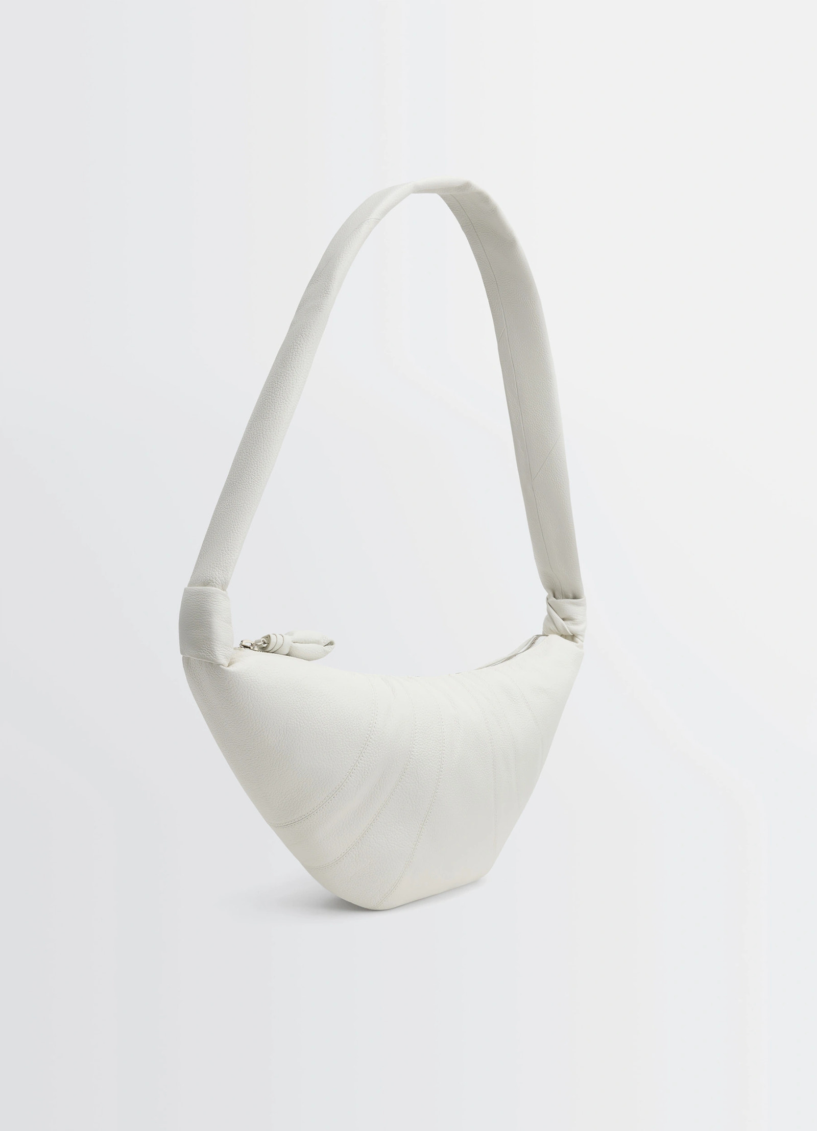 Lemaire medium croissant bag in soft grained leather white, product shot, angled top view arched handle emphasis