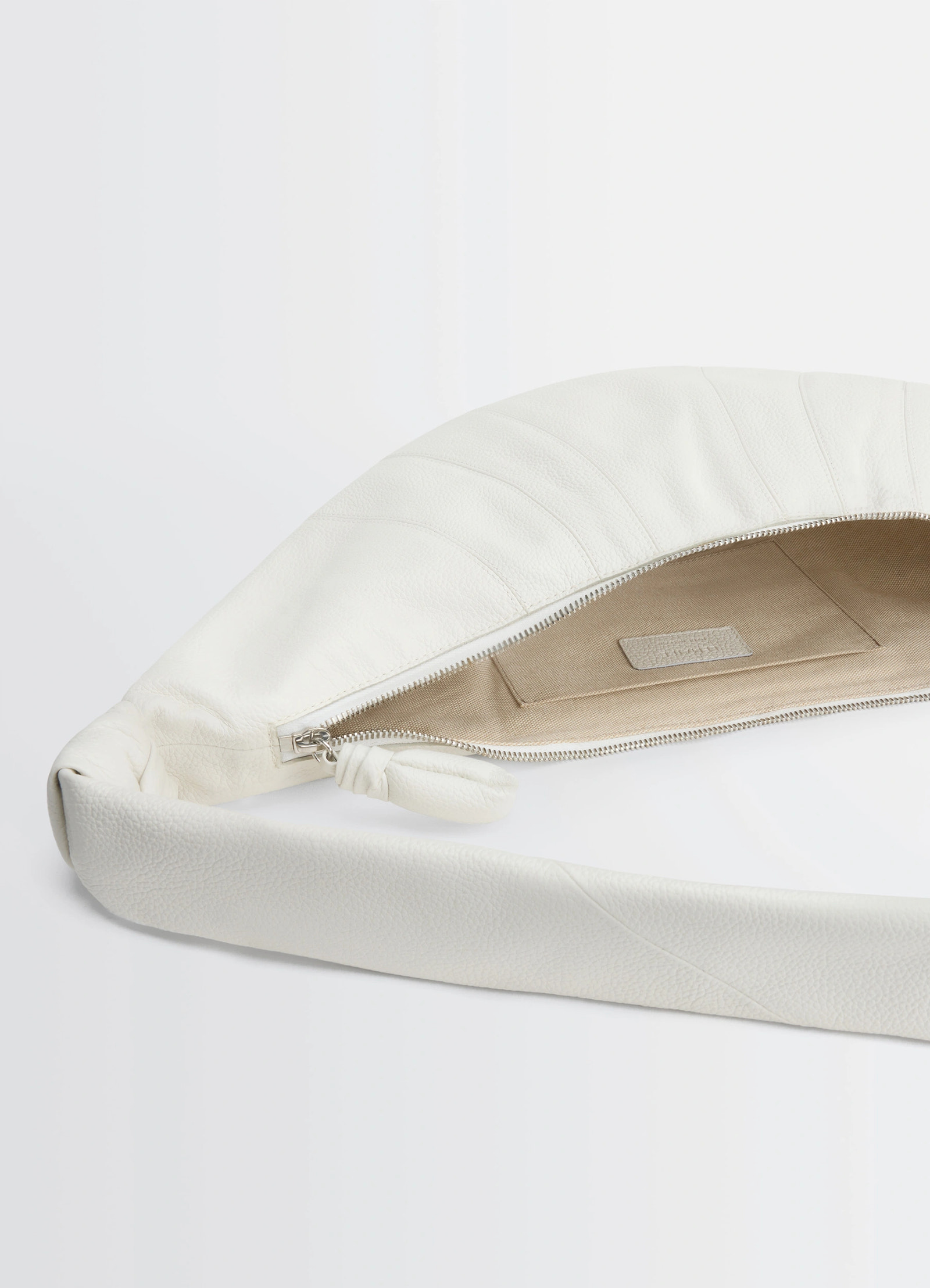Lemaire medium croissant bag in soft grained leather white, product shot, open top view interior zipper detail