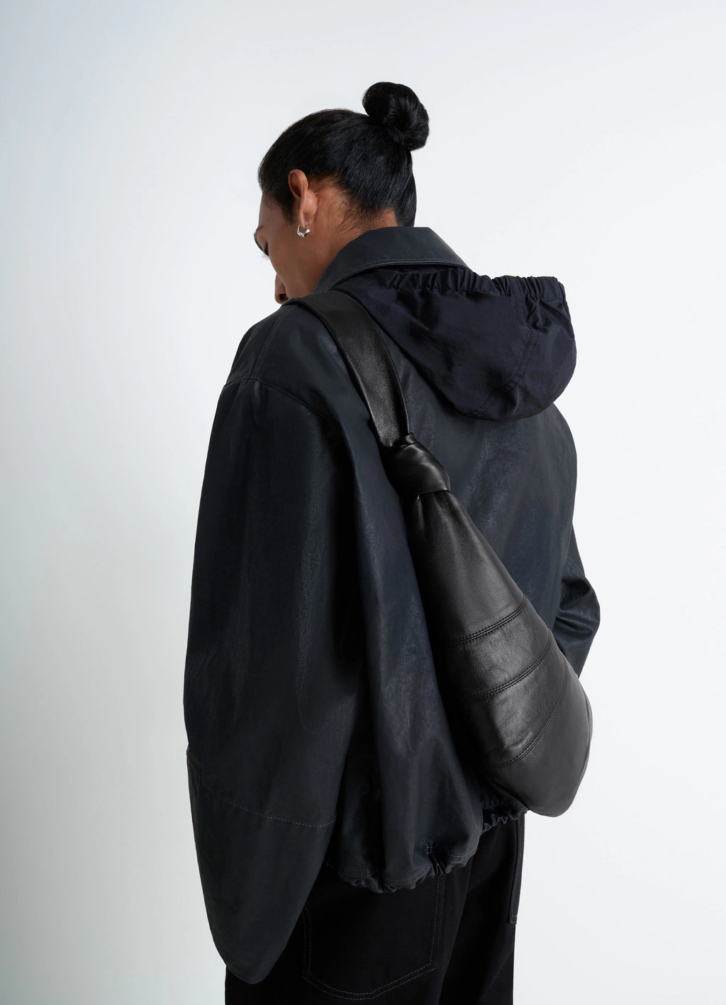 Lemaire Medium Croissant Bag in Black Nappa Lamb Leather, model shot, back view knotted elements