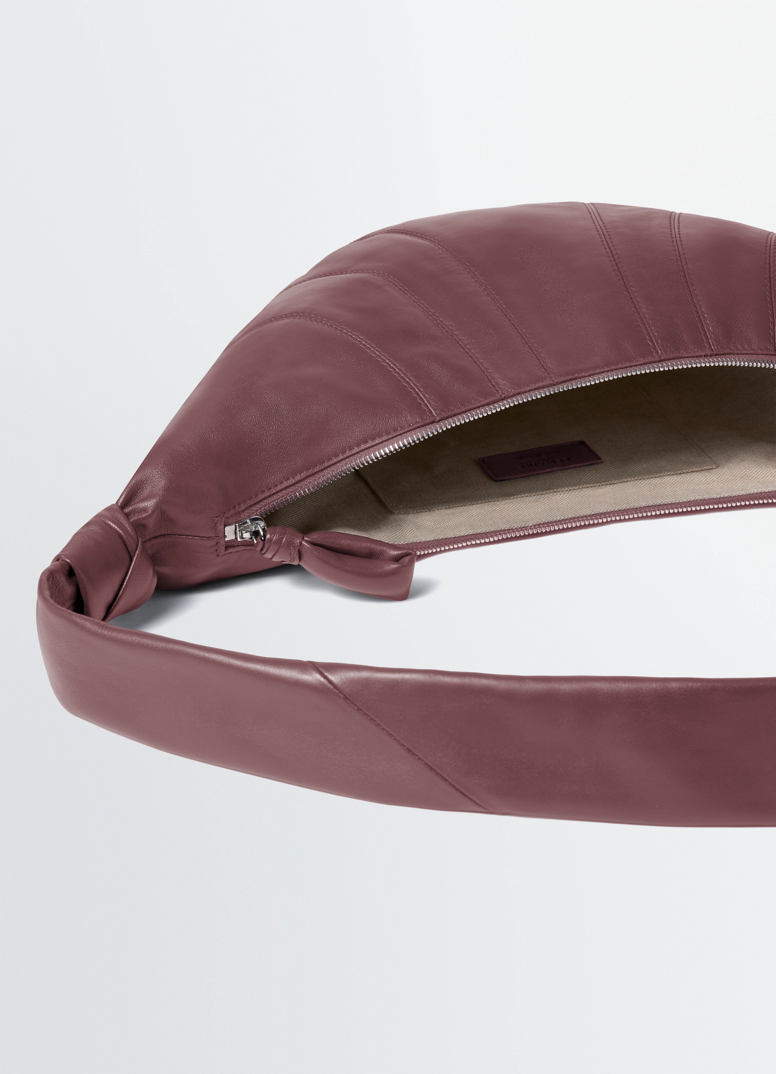 Fortune croissant bag in soft nappa lambskin, product shot, detail top zipper view knotted strap open interior