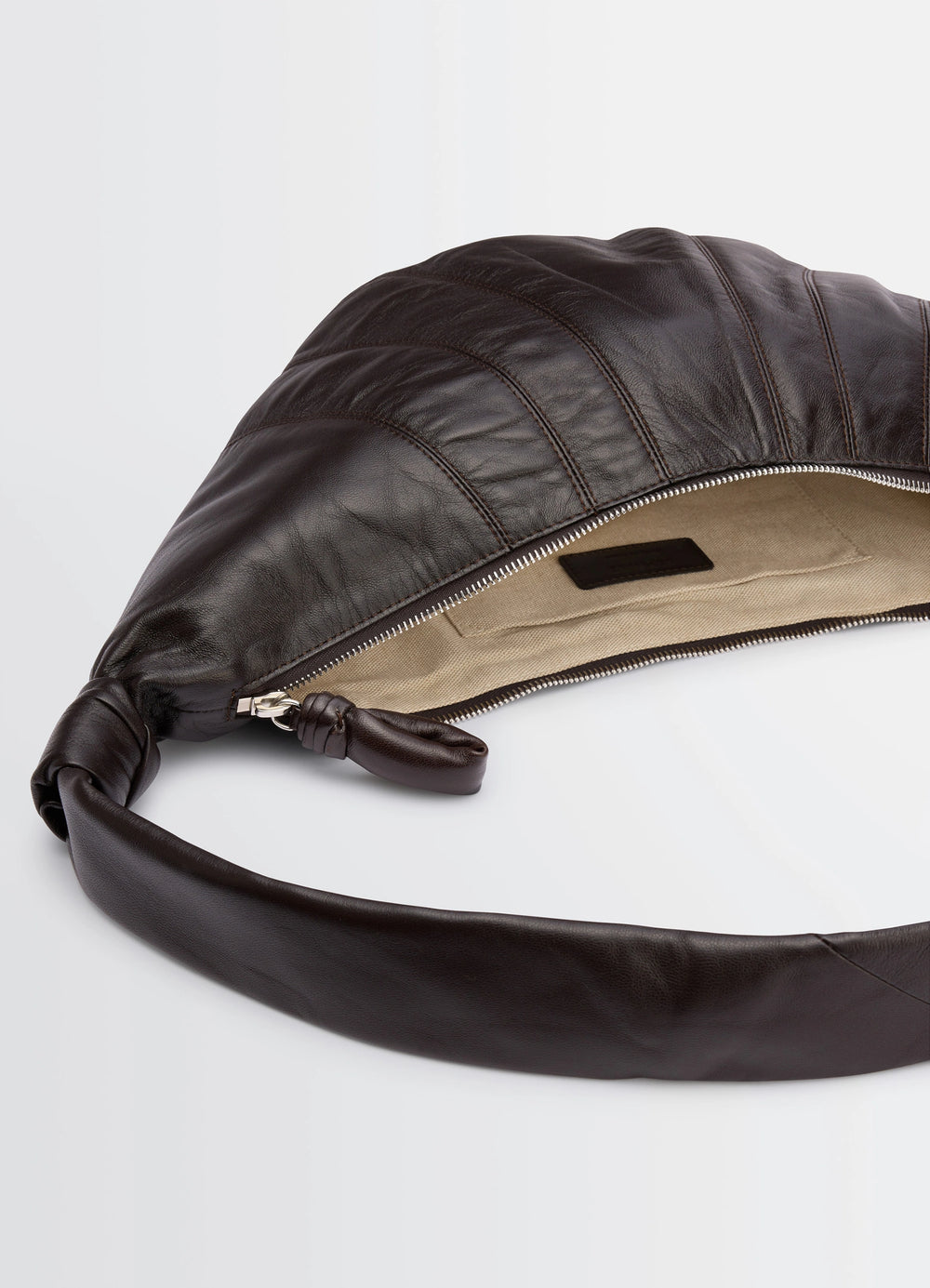 MEDIUM CROISSANT BAG in Nappa lamb leather, product shot, top detail shot zipper pull focus