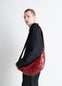 Lemaire Medium Croissant Bag in Coated cotton canvas, model shot, Side view Supple knotted elements