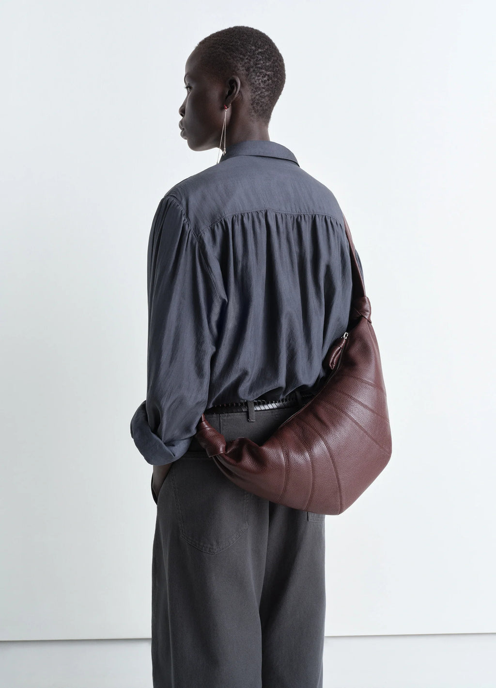 Lemaire Medium Croissant Bag in Grained Leather, model shot, back view curved silhouette