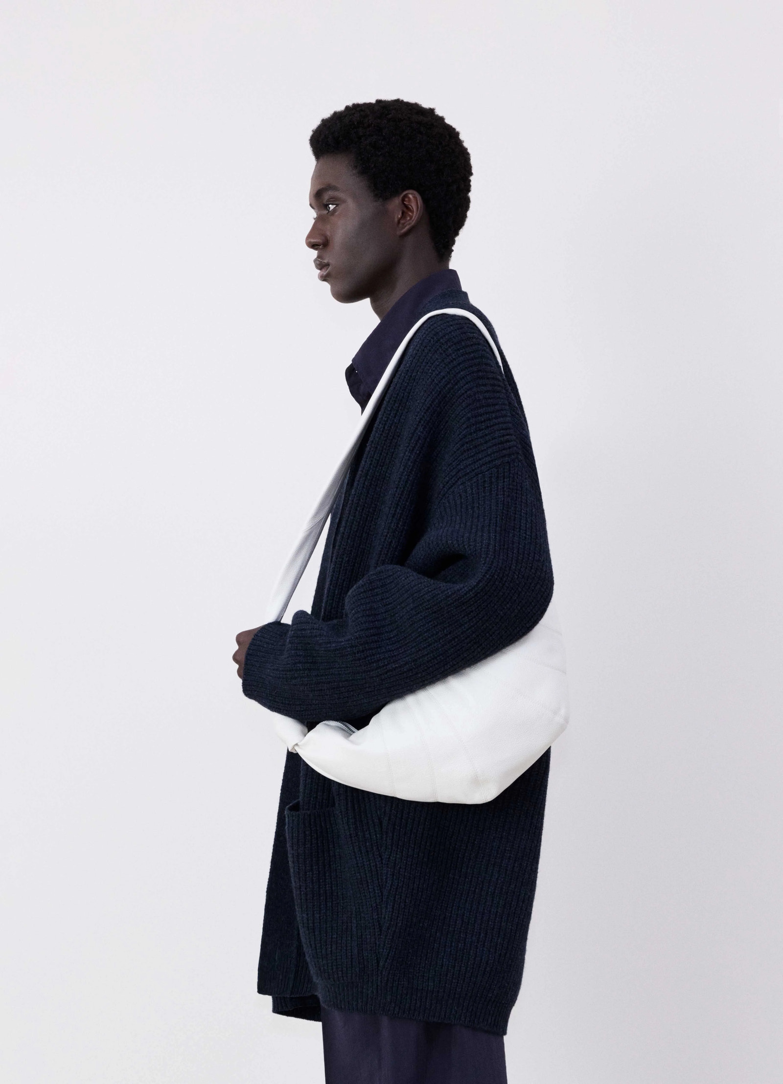 Lemaire medium croissant bag in soft grained leather white, model shot, side view worn over shoulder