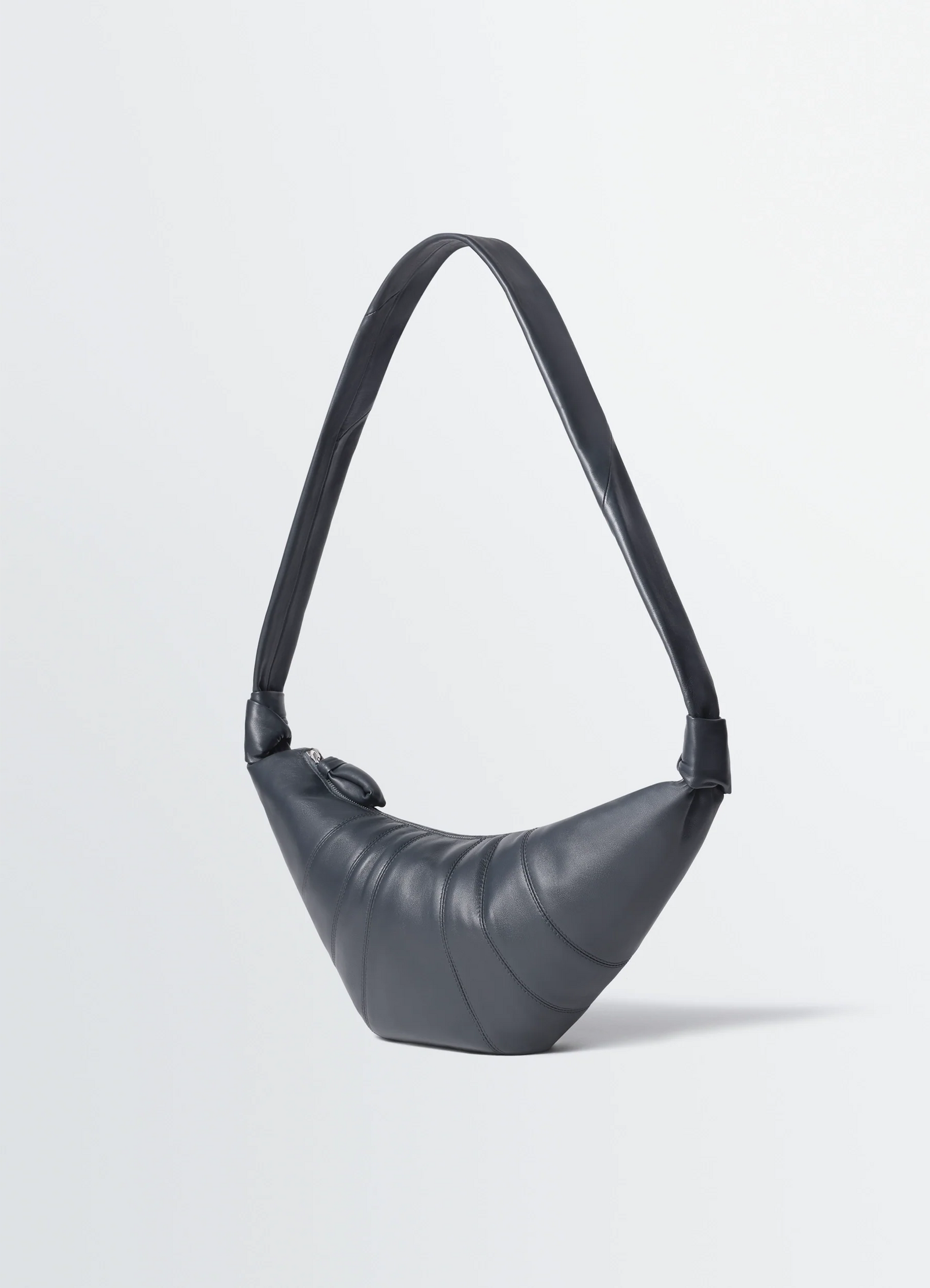Medium croissant bag in leather, product shot, side view curved silhouette