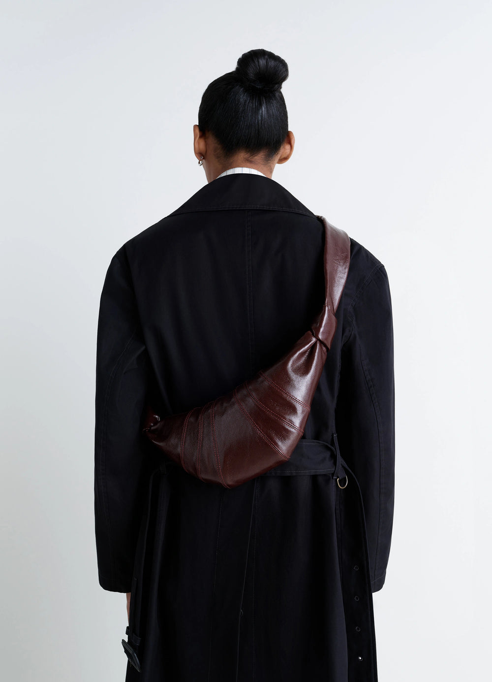 Lemaire Small Croissant Bag in Coated Cotton Canvas, model shot, over-the-shoulder view sleek finish