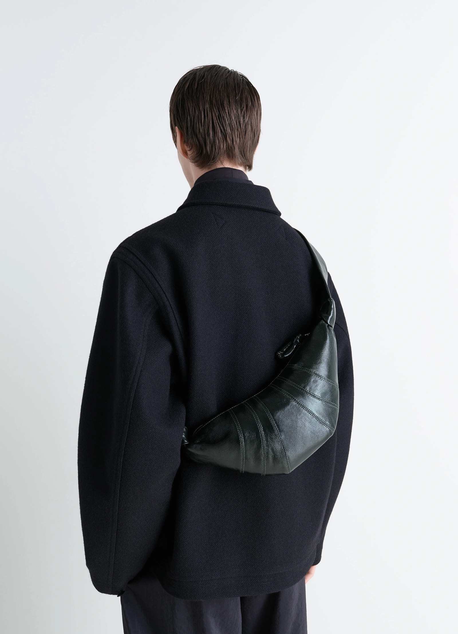 Lemaire small croissant bag in coated cotton canvas, model shot, back view worn on shoulder