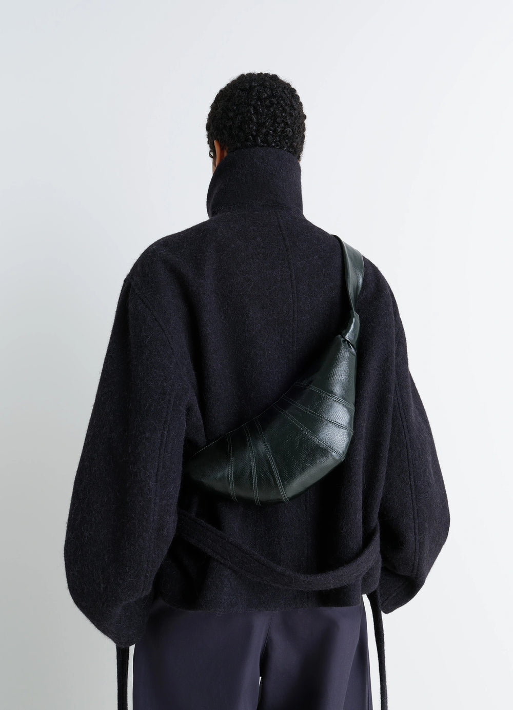 Lemaire Small Croissant Bag in Coated cotton canvas, model shot, rear diagonal view crossbody wear detail