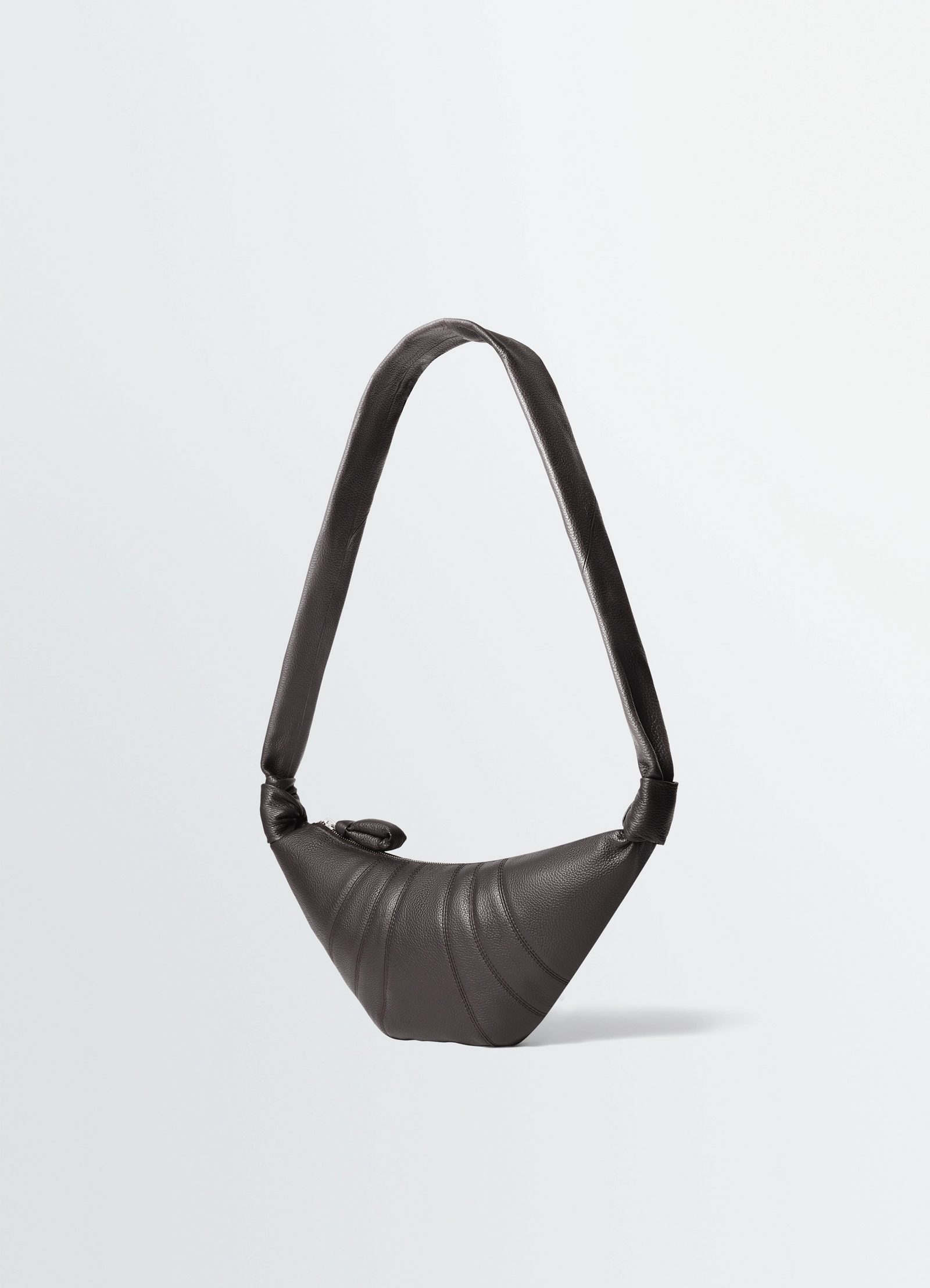 Lemaire small croissant bag in grained leather, product shot, side view asymmetrical shape