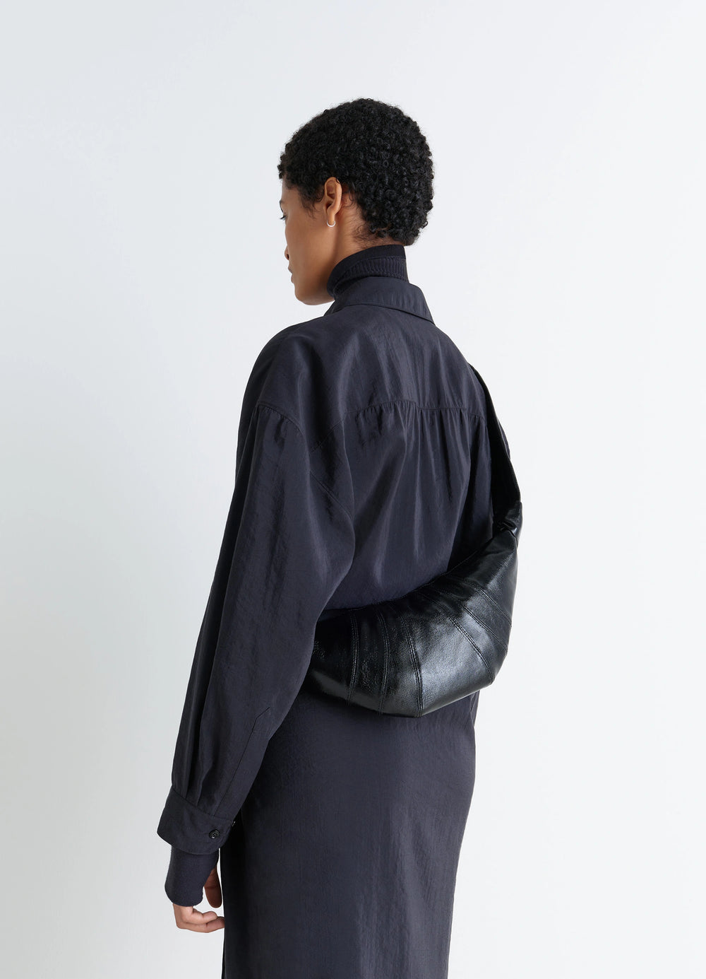 Lemaire Small Croissant Bag in Black Coated Cotton, model shot, Side view Shoulder worn