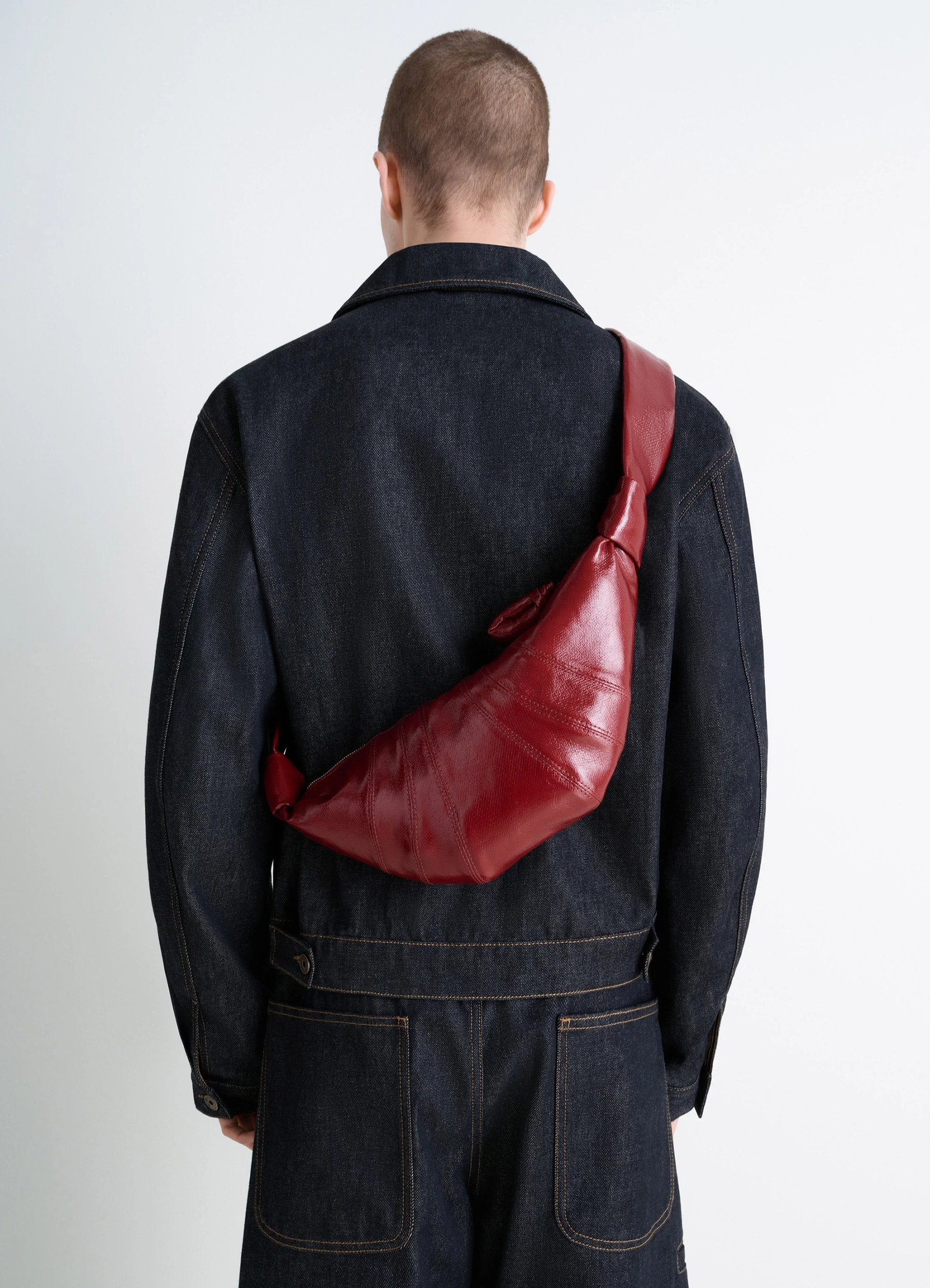 Lemaire small croissant bag in coated cotton canvas, model shot, back view textured shiny look