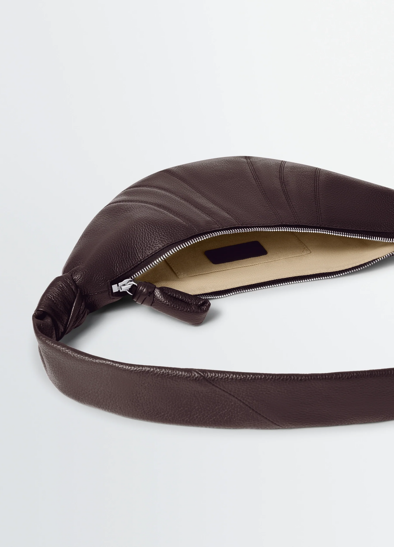 Small croissant bag in grained leather, product shot, top view open zipper interior view