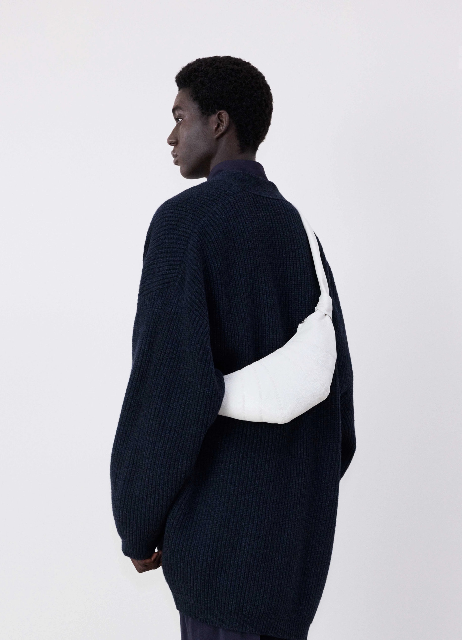 Lemaire small croissant bag in soft grained leather, model shot, back view slouched on shoulder
