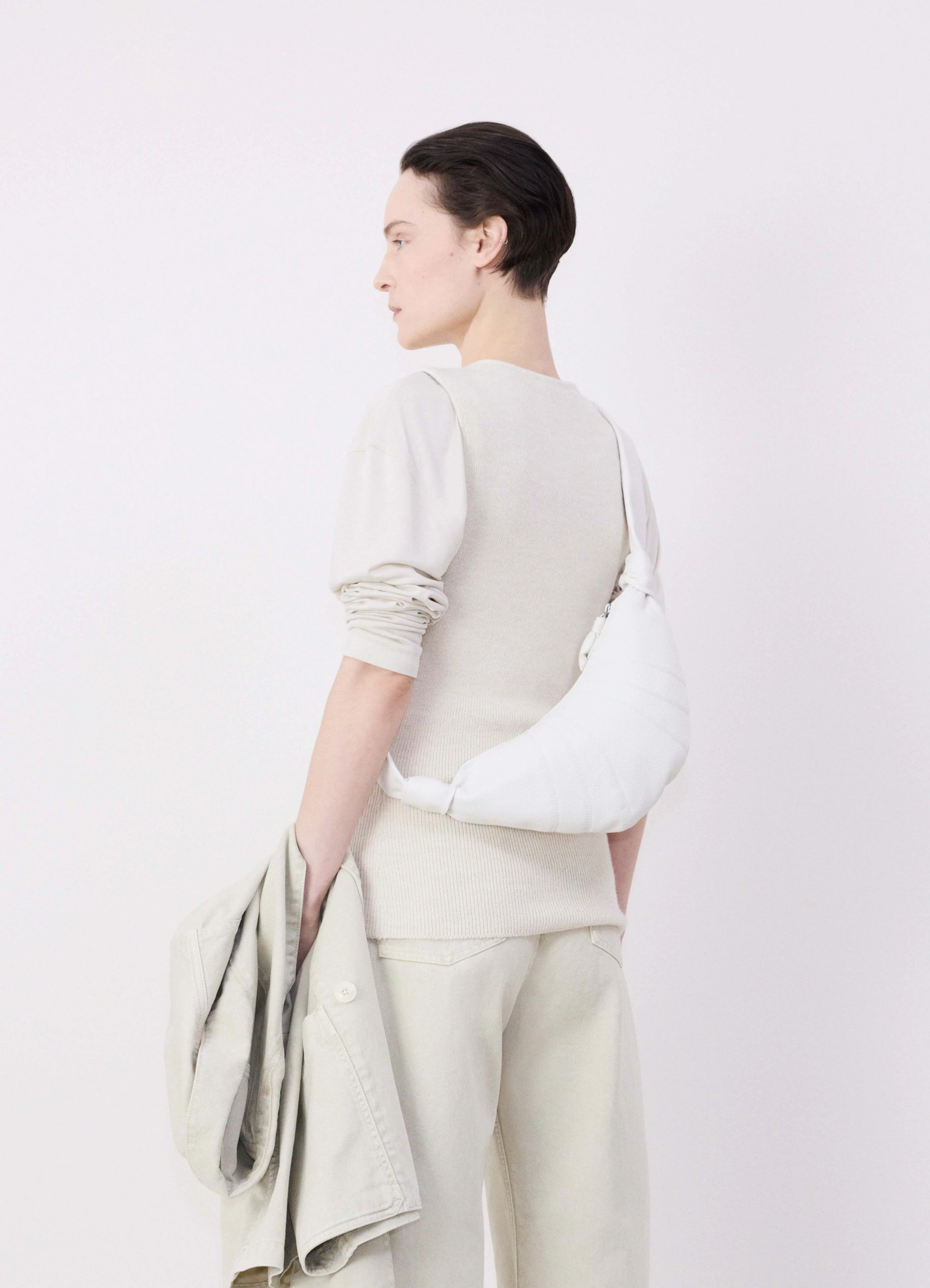 Lemaire small croissant bag in soft grained leather, model shot, side view crossbody styling