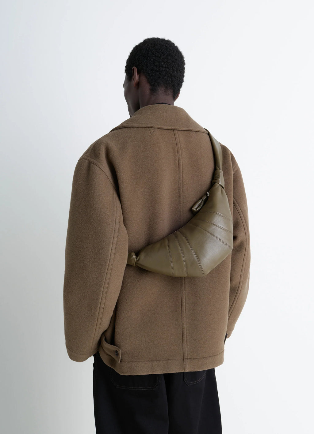 Lemaire Small Croissant Bag in Khaki Nappa Lamb Leather, model shot, back view worn over shoulder