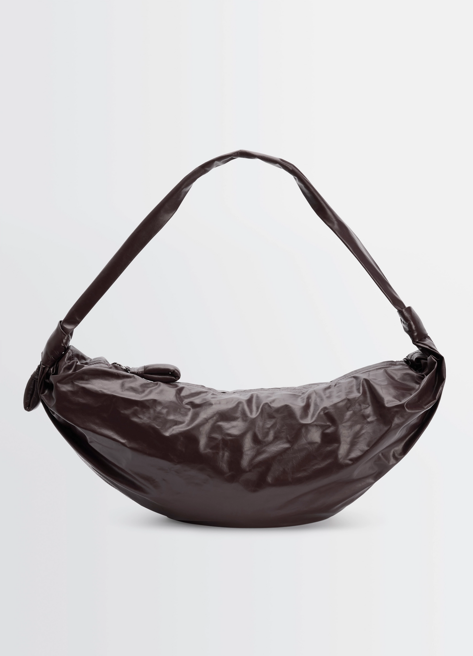 Large soft croissant bag in paper-effect leather, product shot, side view curve with side pleats