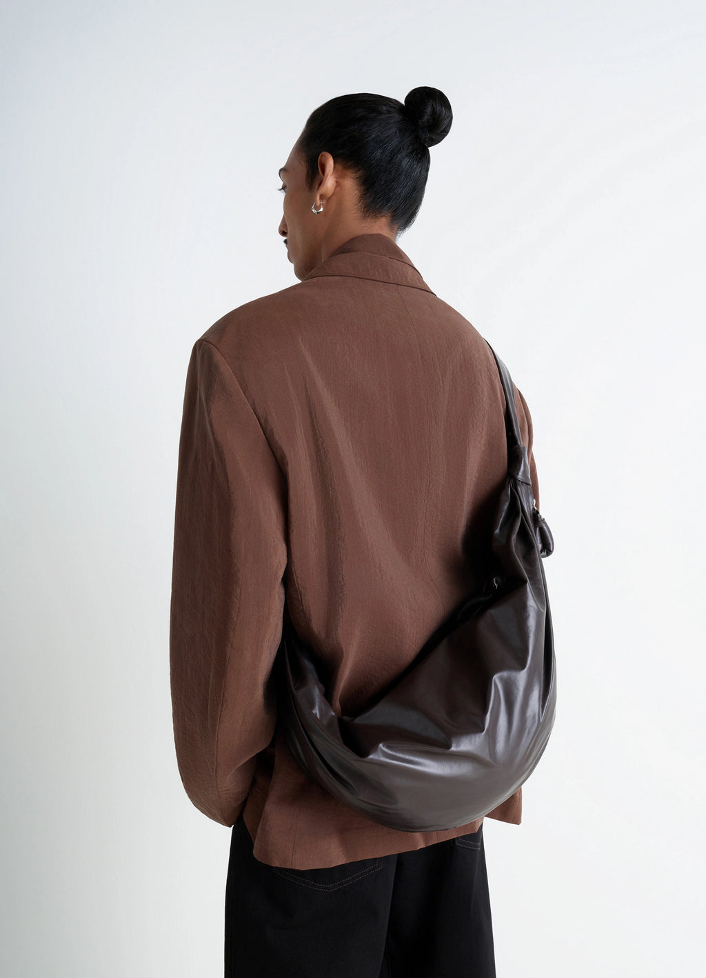 Lemaire Large Soft Croissant Bag in Paper-effect leather, model shot, Back view Curved design with pleats