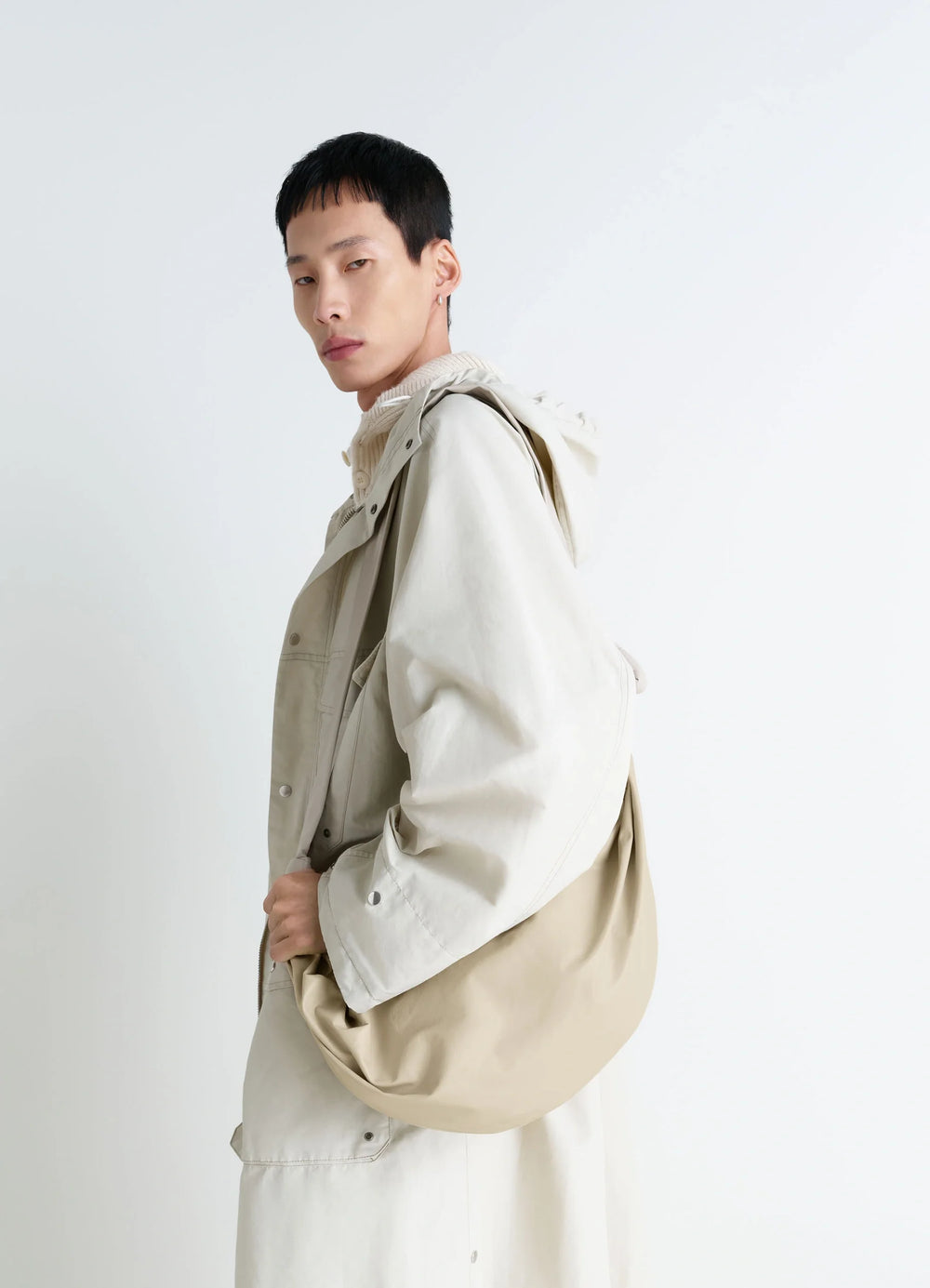 Lemaire Large Soft Croissant Bag in Paper-effect Leather, model shot, Side view Knotted elements