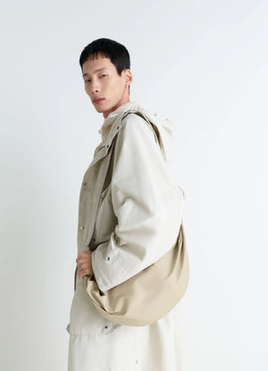 Lemaire Large Soft Croissant Bag in Paper-effect Leather, model shot, Side view Knotted elements