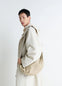 Lemaire Large Soft Croissant Bag in Paper-effect Leather, model shot, Side view Knotted elements