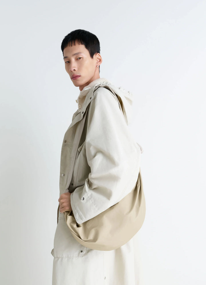 Lemaire Large Soft Croissant Bag in Paper-effect Leather, model shot, Side view Knotted elements