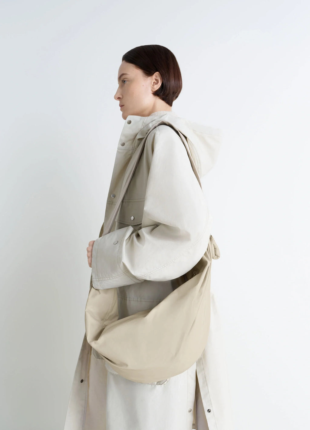 Lemaire Large Soft Croissant in Paper-effect leather, model shot, three-quarter view worn over shoulder