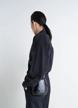 Il Bussetto for Lemaire Small Cartr in Patinated Vegetable-Tanned Leather, model shot, Back side view Worn crossbody