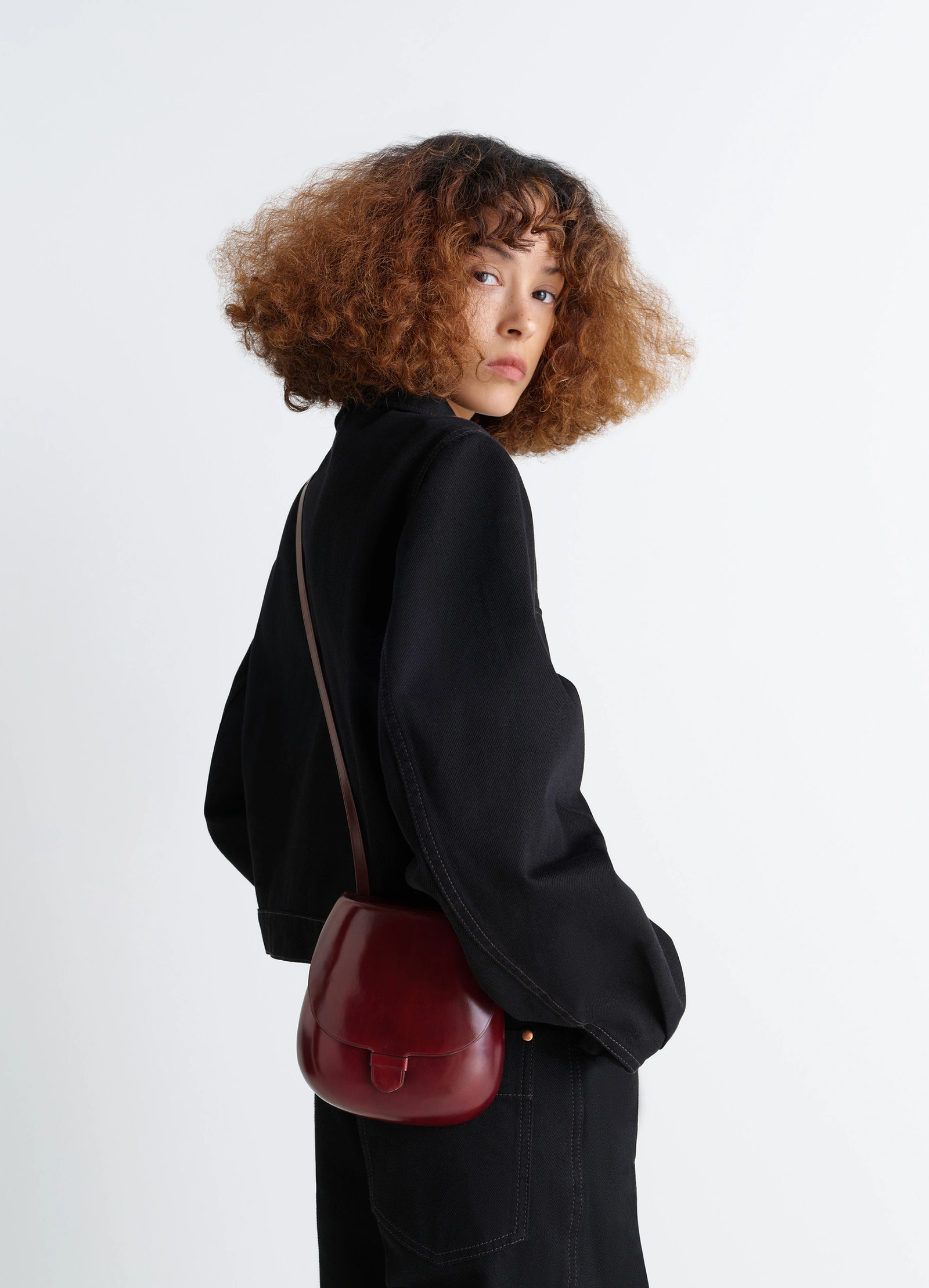 Il bussetto for lemaire small cartr in patinated vegetable-tanned leather, model shot, side view worn over shoulder