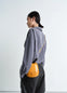 IL BUSSETTO FOR LEMAIRE SMALL CARTR in Vegetable-tanned cowhide, model shot, Back side view Adjustable strap worn cross-body