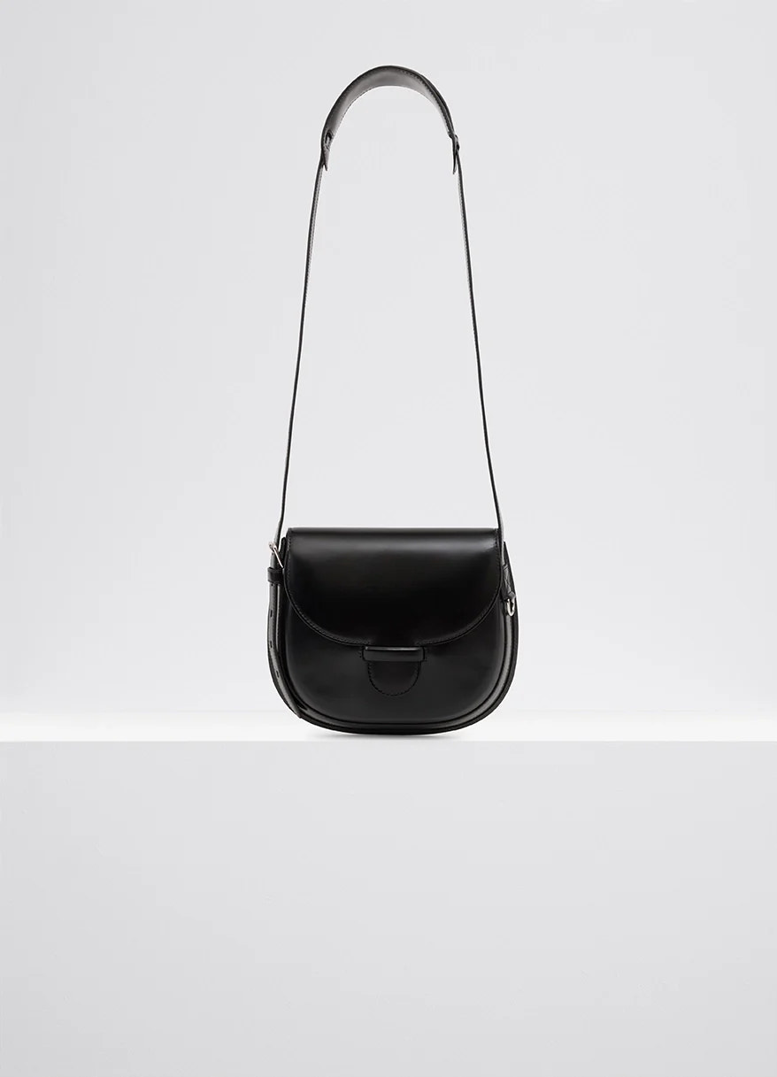 Lemaire cartridge sport bag in black vegetable-tanned leather, product shot, front view smooth, molded shape