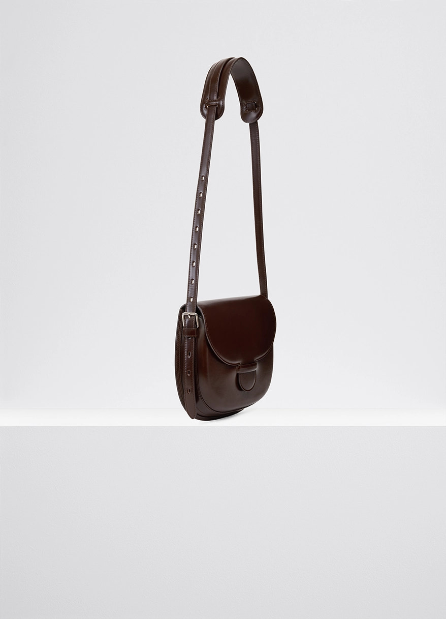 Lemaire cartridge sport bag in smooth vegetable-tanned leather, product shot, three-quarter view adjustable strap