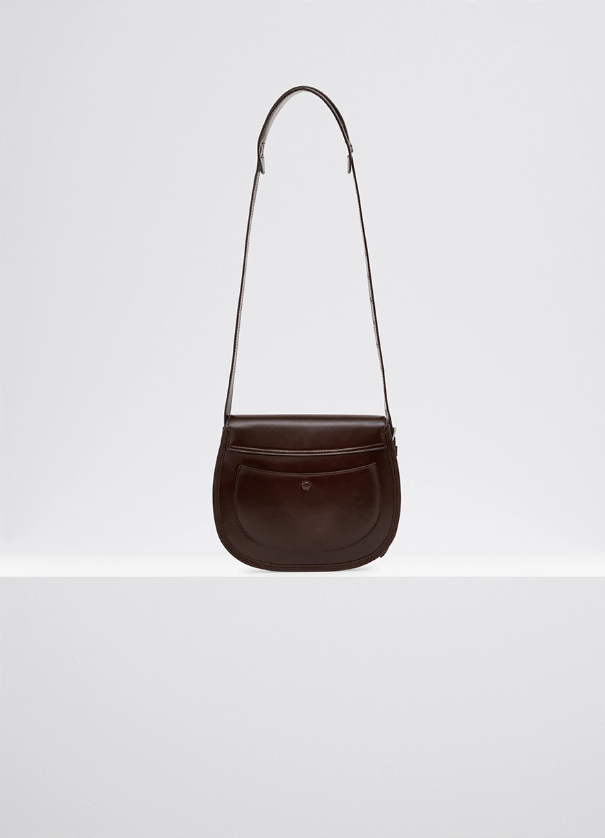 Lemaire cartridge sport bag in smooth vegetable-tanned leather, product shot, back view curved silhouette