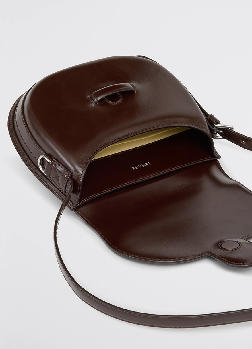Lemaire cartridge sport bag in smooth vegetable-tanned leather, product shot, top open view inner compartment detail