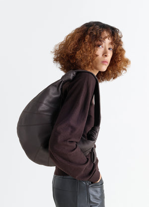 Fortune Croissant Bag in Grained Leather, model shot, Side view Half-moon silhouette