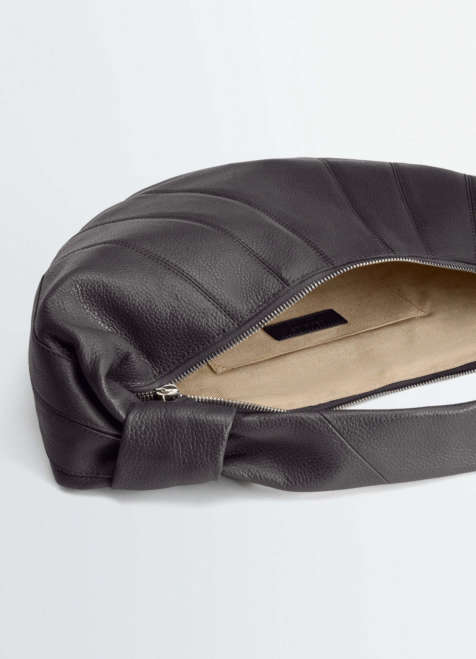 Fortune croissant bag in leather, product shot, top zipper view stitched paneling detail