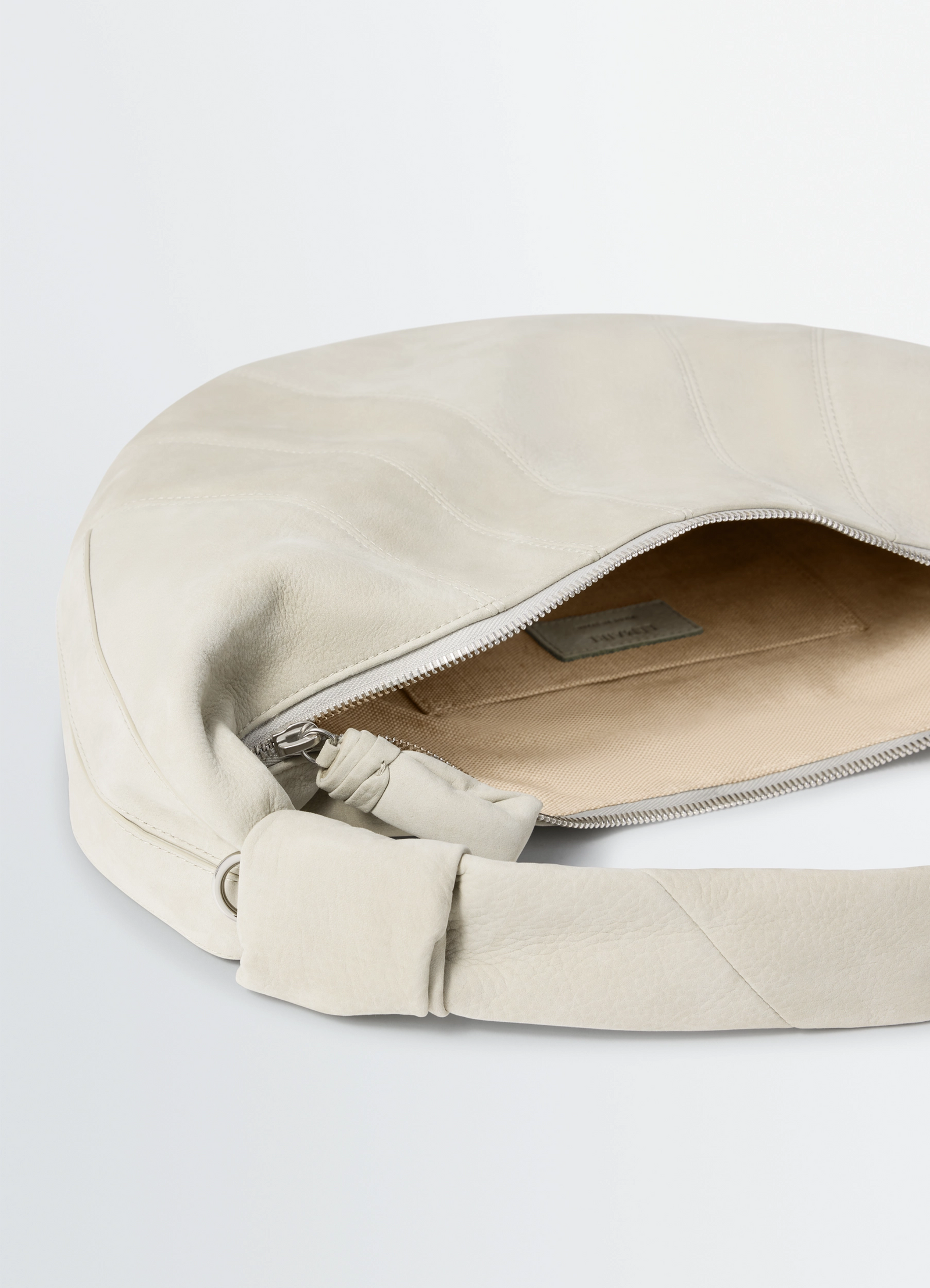 Fortune croissant bag in alpaca nubuck, product shot, top zipper detail knotted strap texture