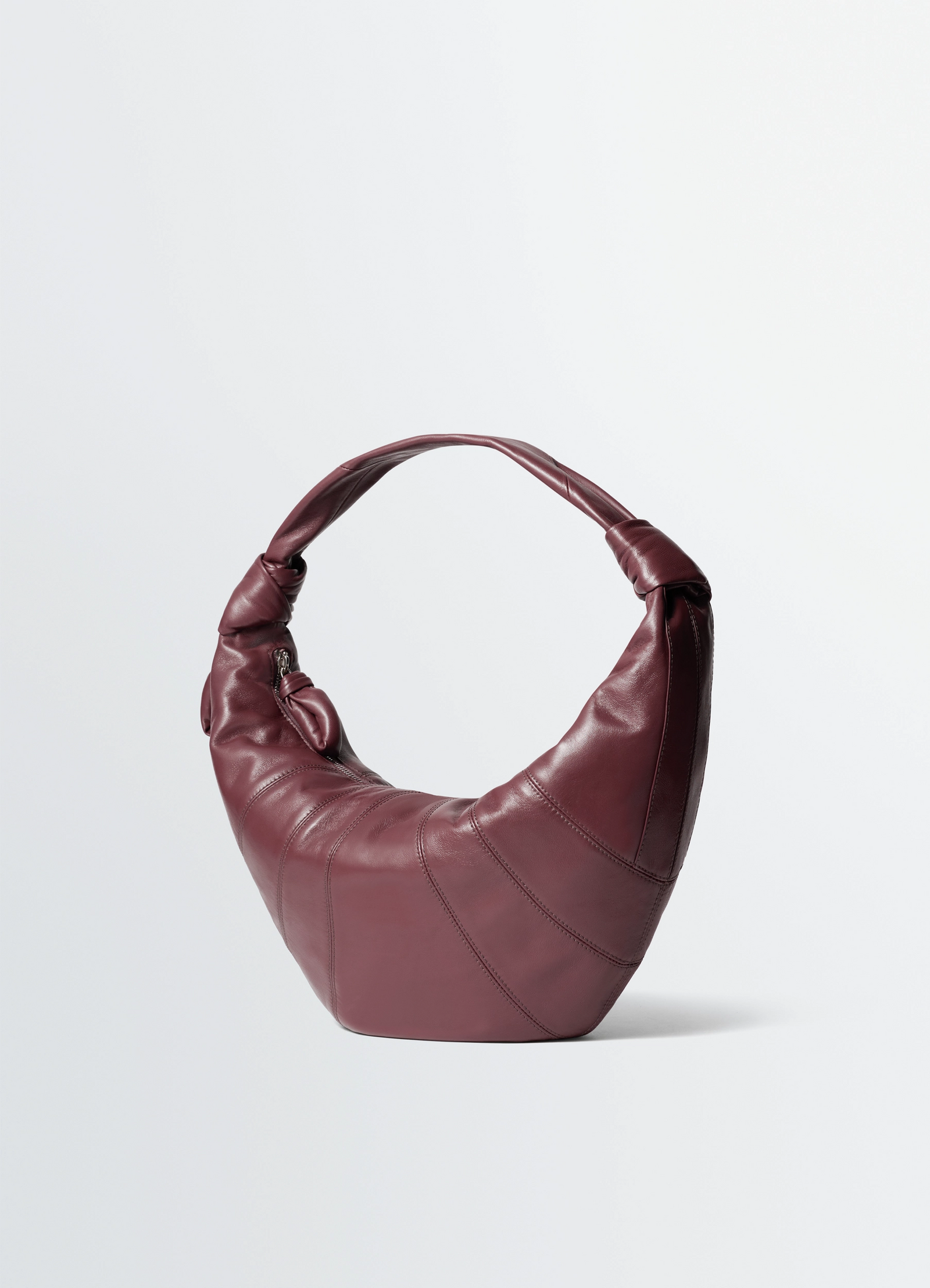 Fortune croissant bag in leather, product shot, three-quarter view wrapped strap with seams