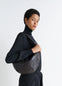 Fortune Croissant Bag in Soft Nappa Lambskin, model shot, Side view Half-moon silhouette