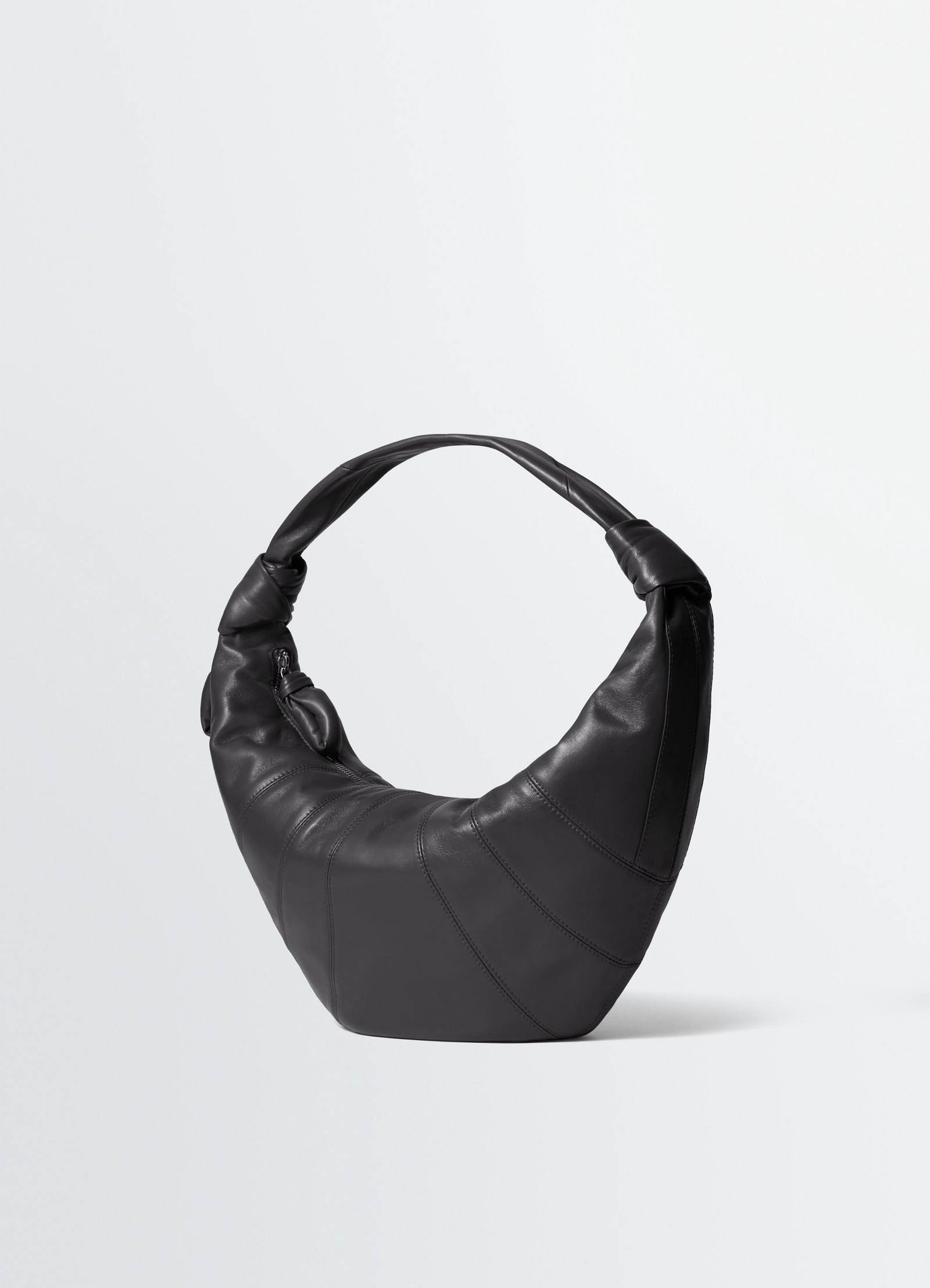 Fortune croissant bag in leather, product shot, three-quarter view stitch detail, padded handle