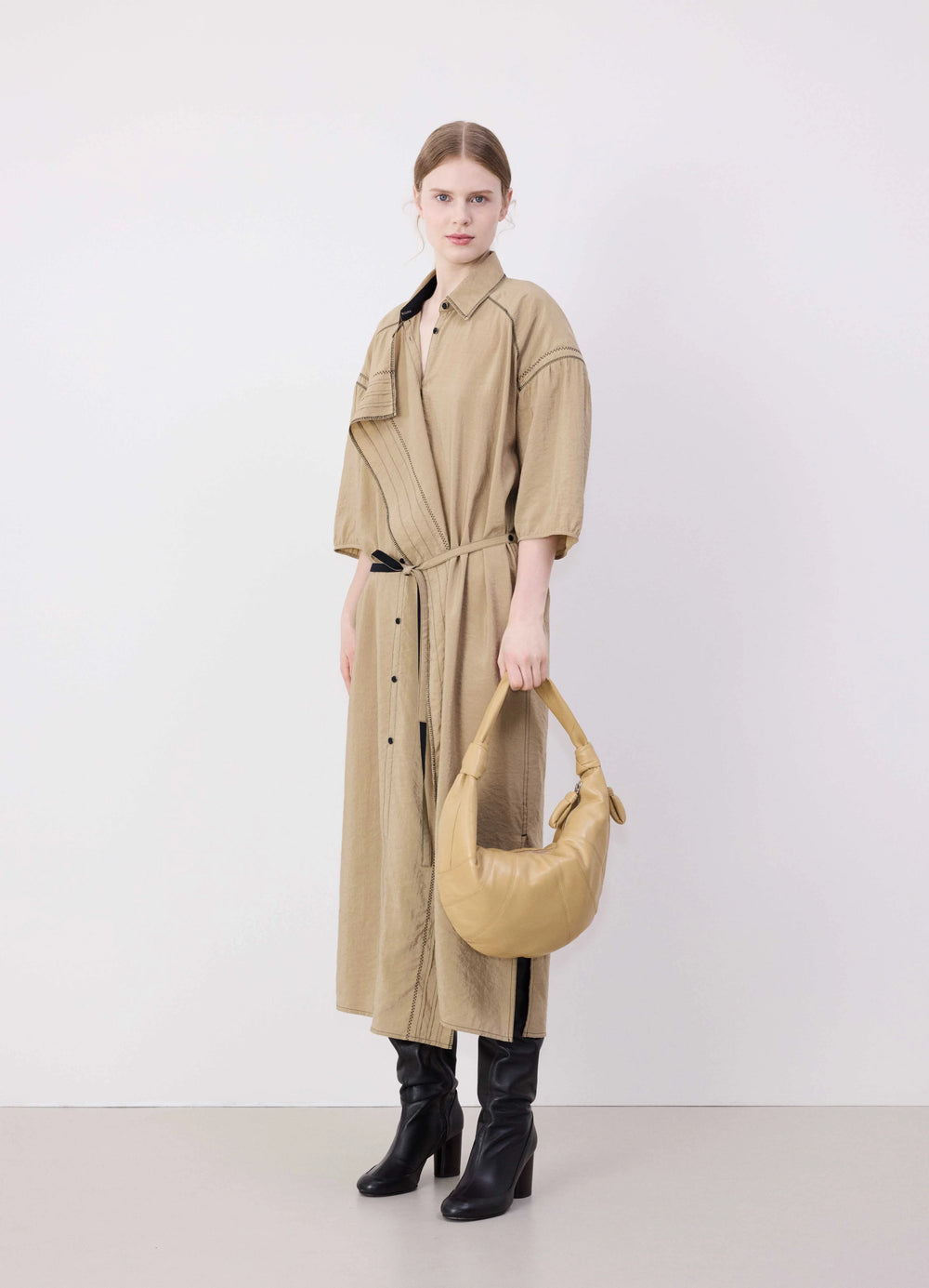 Lemaire Fortune Croissant Bag in Tan Nappa Lamb Leather, model shot, porte side view carried by model