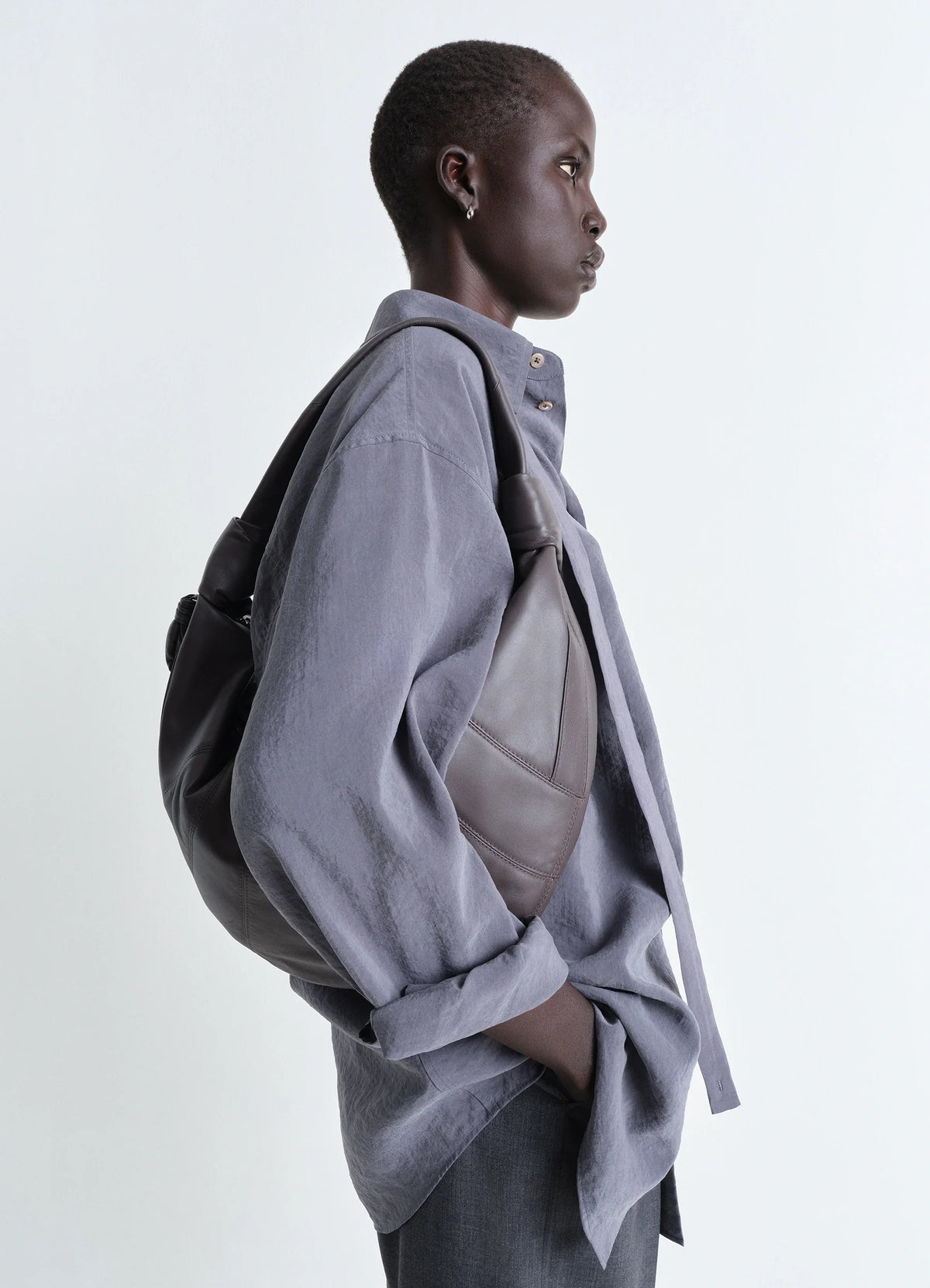 Lemaire Fortune Croissant Bag in Soft nappa lamb leather, model shot, Side view Folded crescent design