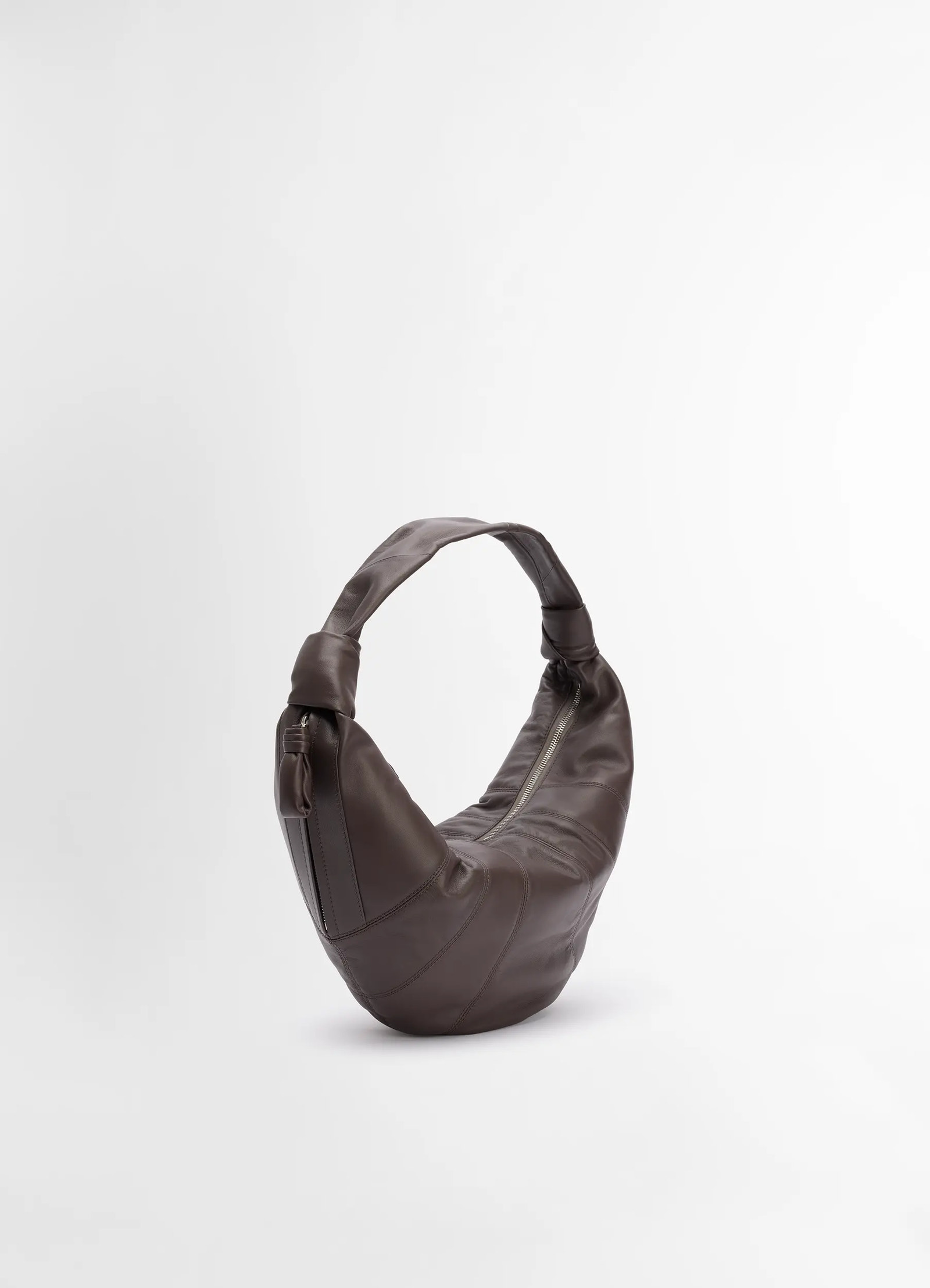 Lemaire fortune croissant bag in soft nappa lamb leather, product shot, three-quarter view zippered top, curved strap
