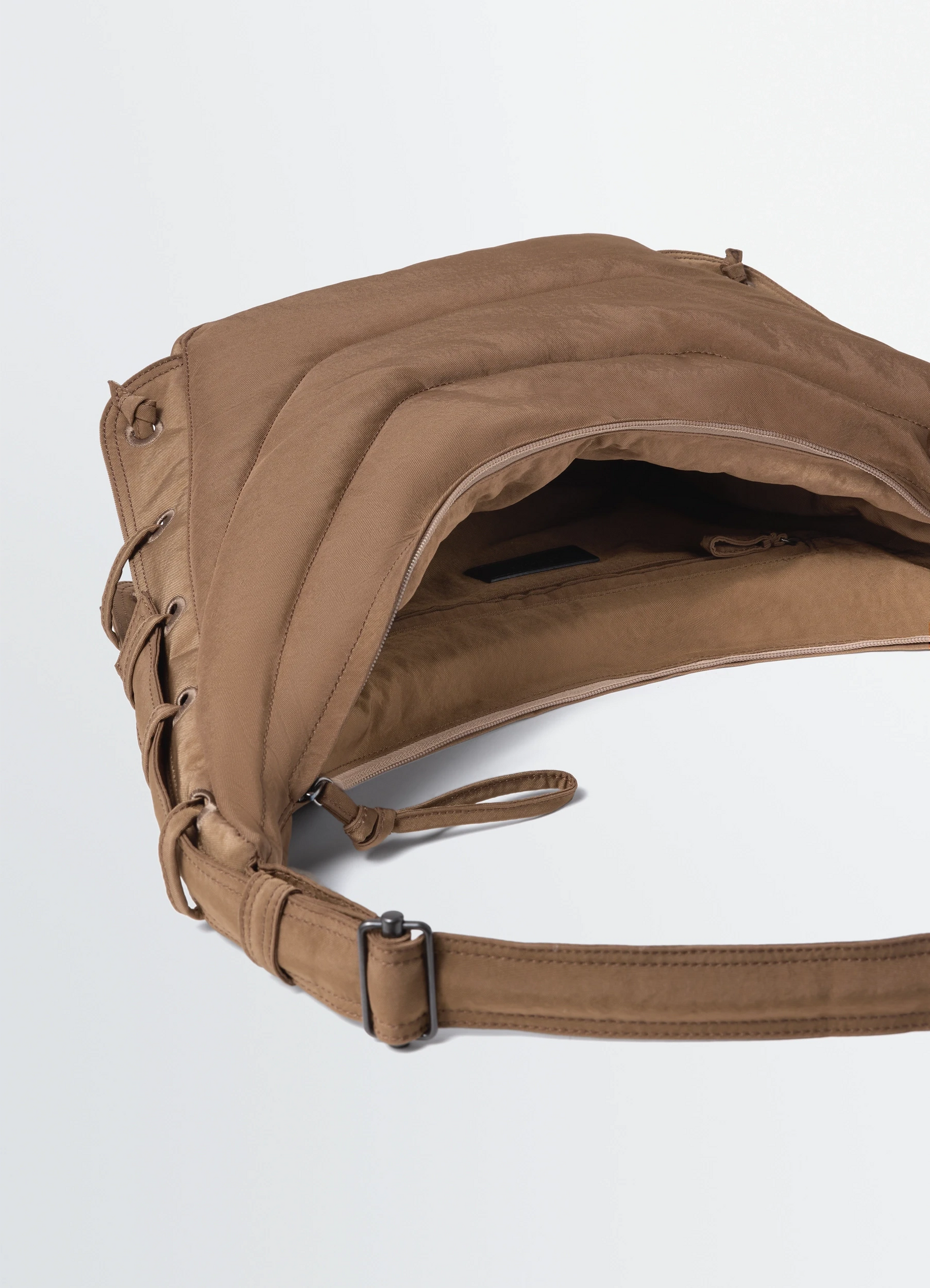 Medium soft game bag in quilted water-repellent nylon canva, product shot, top angled view strap with buckle detail