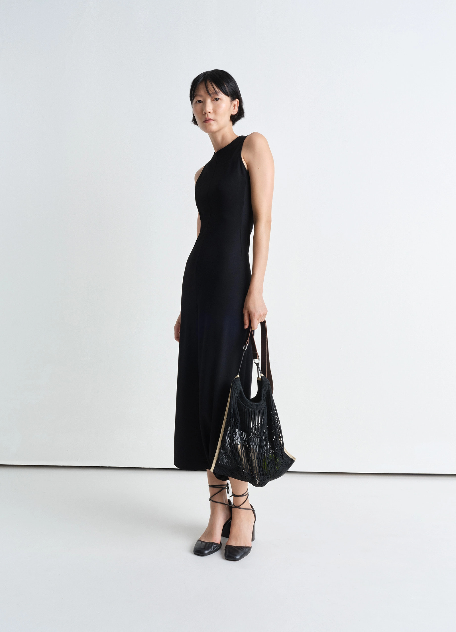 Large crossbody filt net bag in dark chocolate leather nylon, model shot, front view worn by model